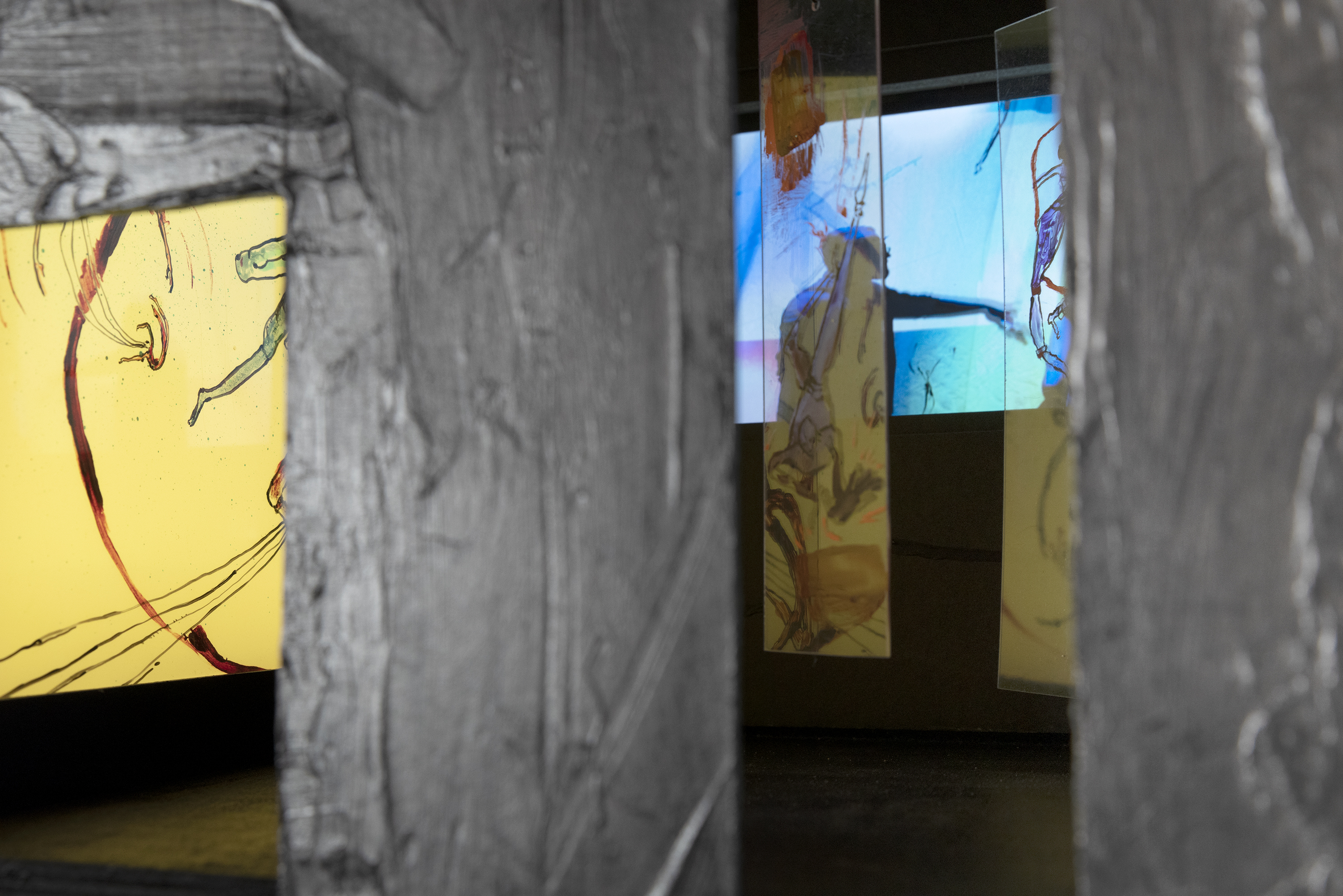 looking in to the front openings - clear painted acrylic panels in front of video with white color back-lit panel on the left